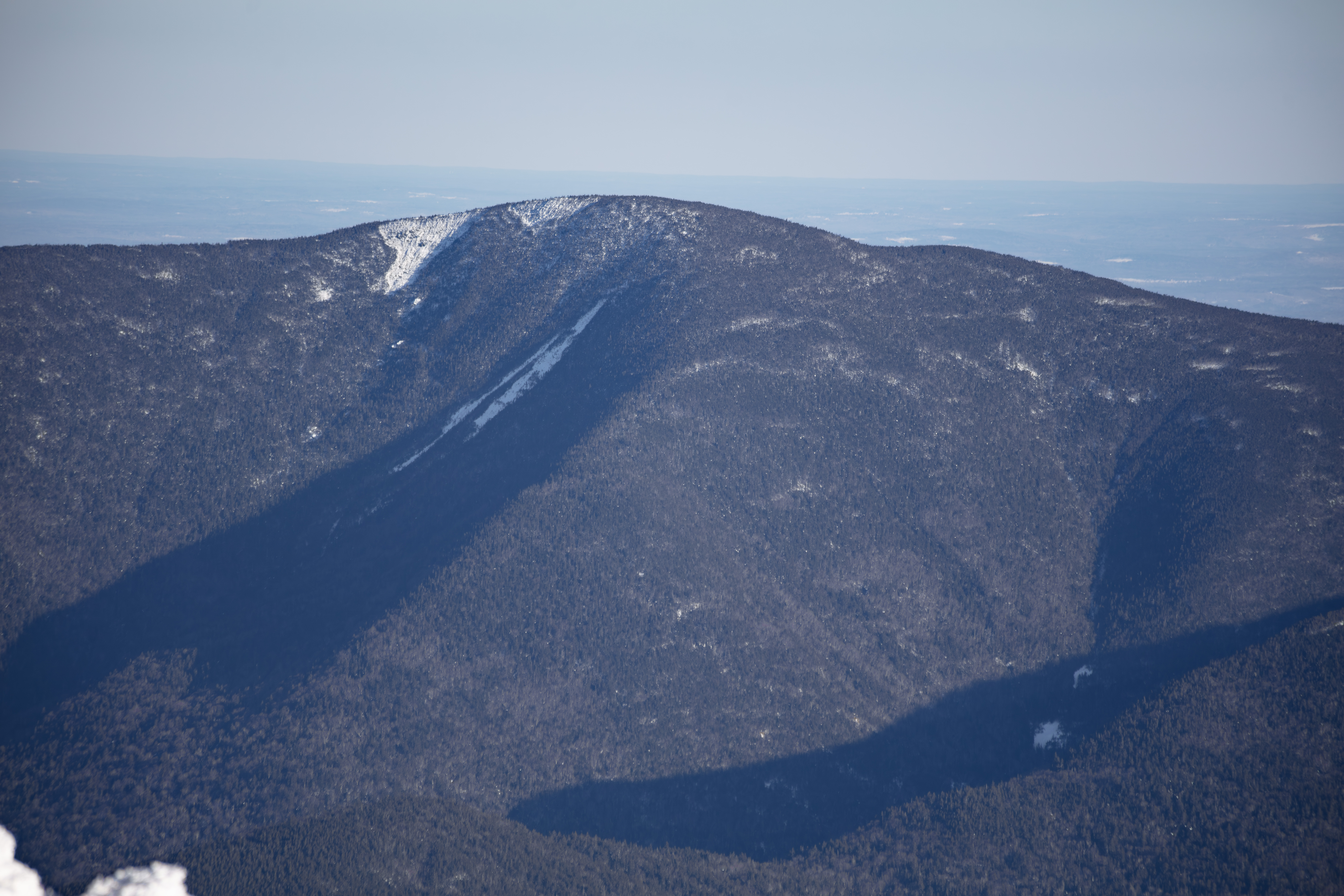 Carter Dome mountain in winter with shadows and snow patches