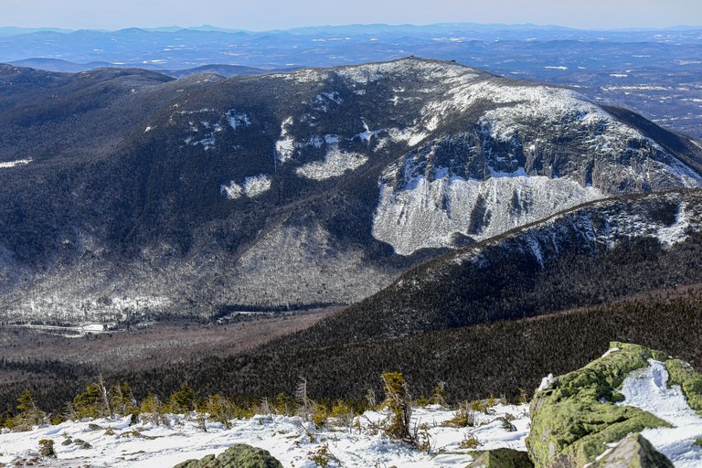 Cannon Mountain with snow patches and forest in White Mountains, New Hampshire
