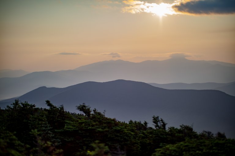 Mount Hale silhouette at dawn with layered mountain ridges and soft sunlight