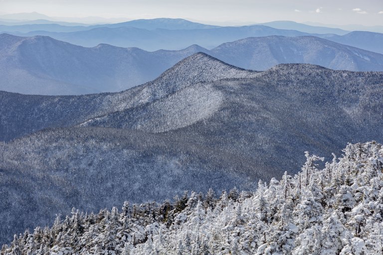 Snow-covered Mount Hancock South in White Mountains with frosted trees in foreground