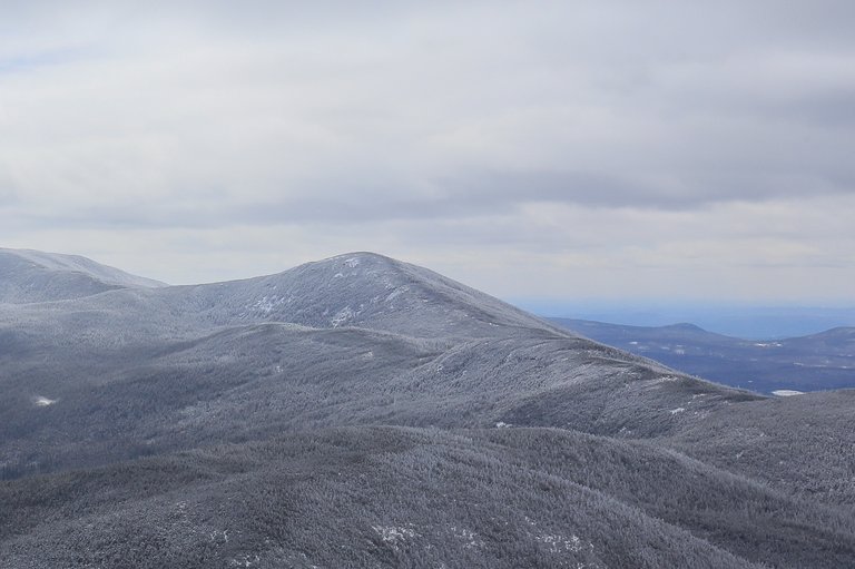 Cloudy sky over frost-covered North Kinsman Mountain in White Mountains, New Hampshire