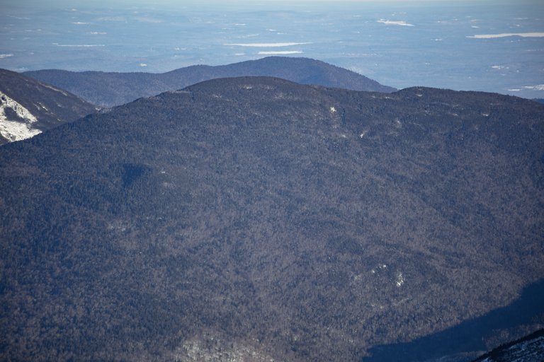 Wildcat Mountain A in winter afternoon light with snowy forested ridges