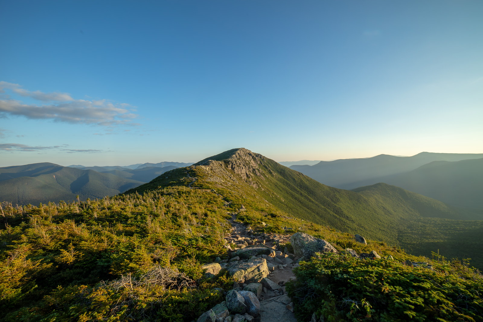 Rocky trail to Bondcliff summit under clear sunset sky in White Mountains