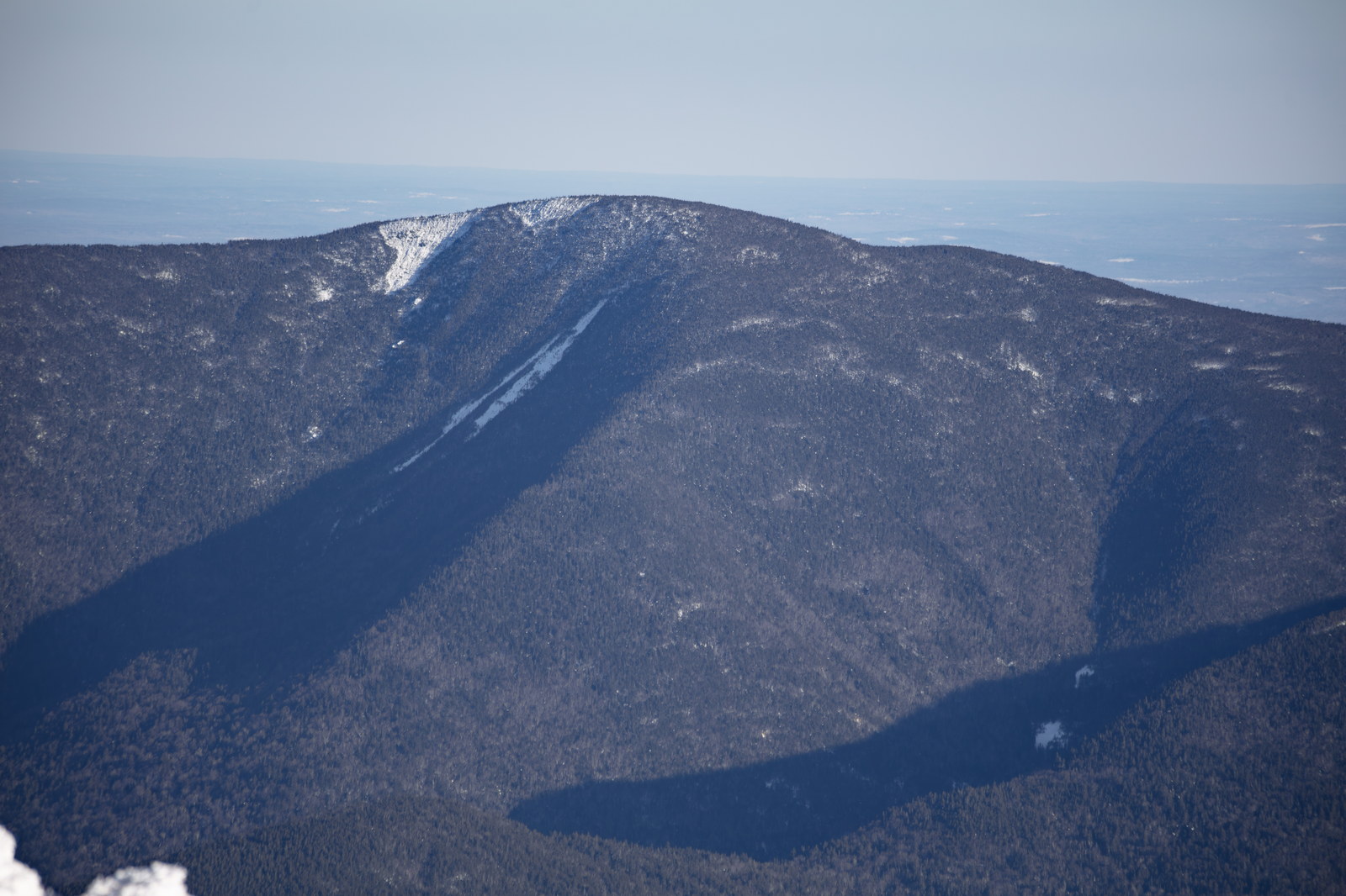 Carter Dome mountain in winter with shadows and snow patches