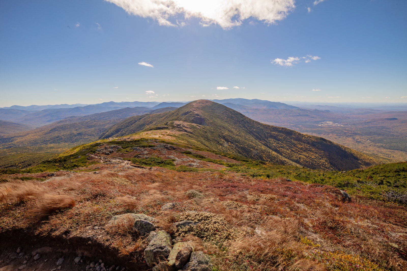 Mount Eisenhower ridge line with fall colors under a bright blue sky in White Mountains