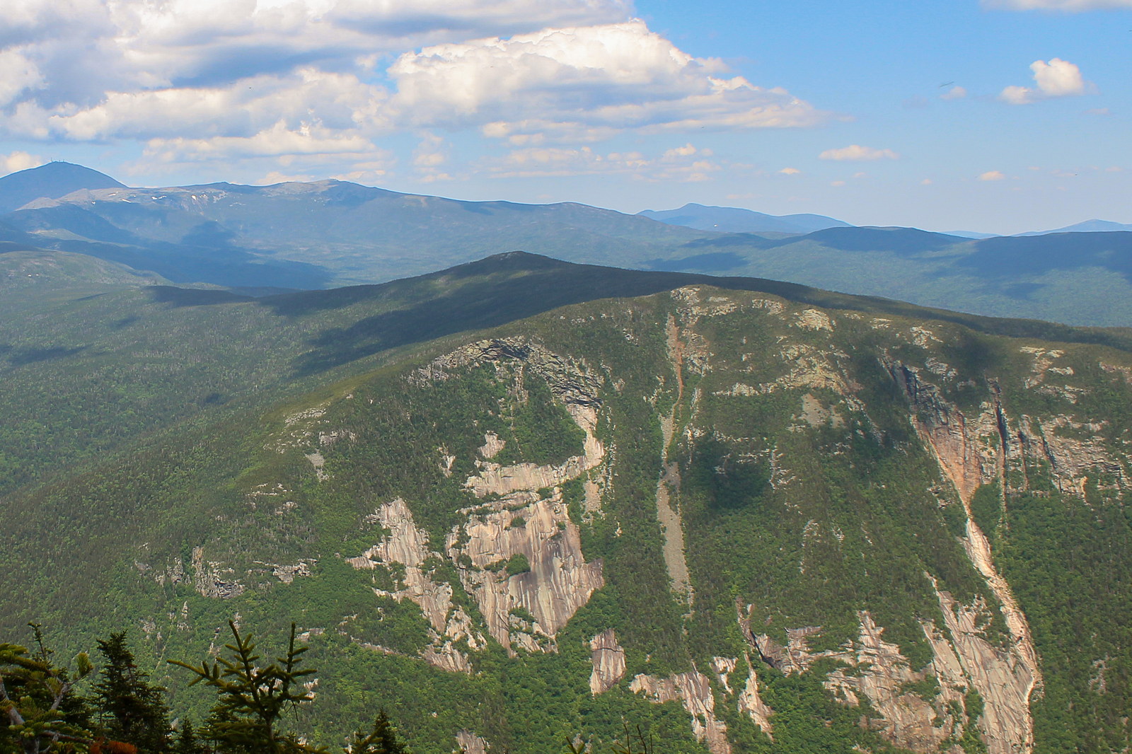 Mount Jackson ridge line with granite ledges and forest under blue sky in White Mountains