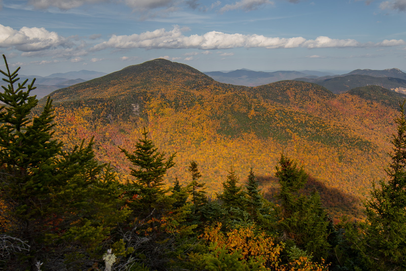 Mount Passaconaway ridge in fall with colorful trees and blue sky