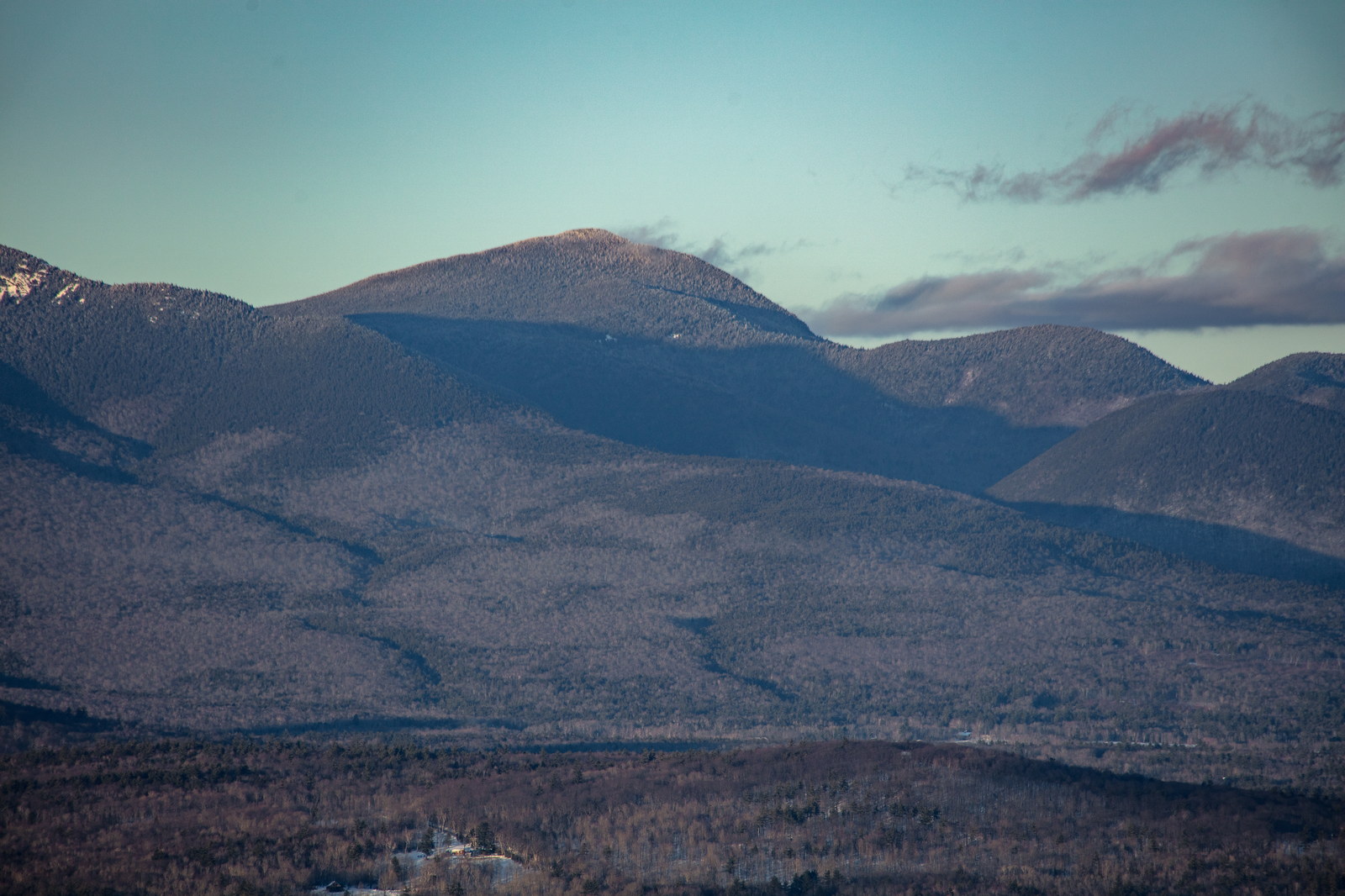 Mount Passaconaway in winter with soft afternoon light and long shadows
