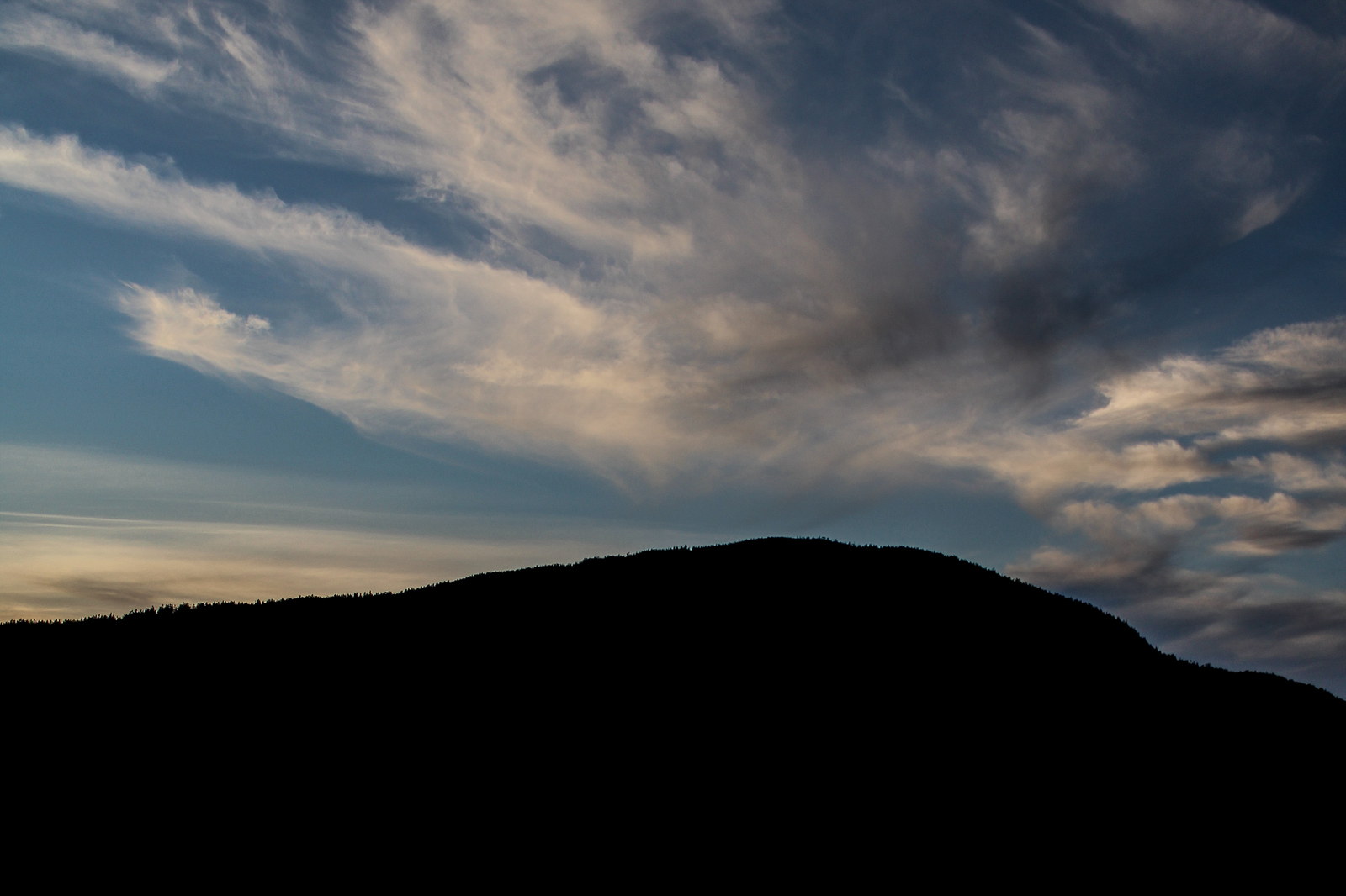 Silhouette of Mount Tom under soft evening clouds in White Mountains
