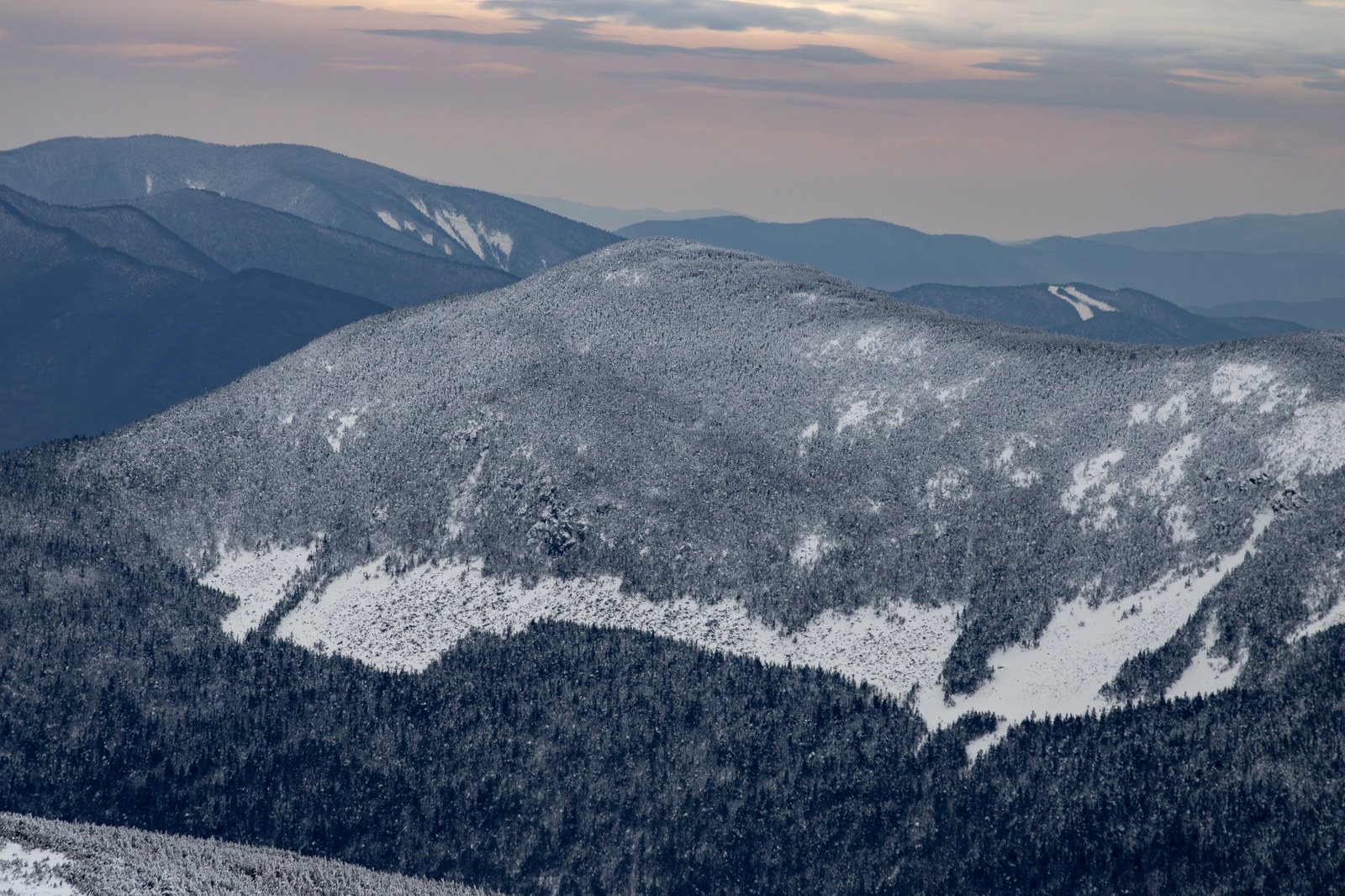 Snow-covered Mount Willey in White Mountains under cloudy winter sky