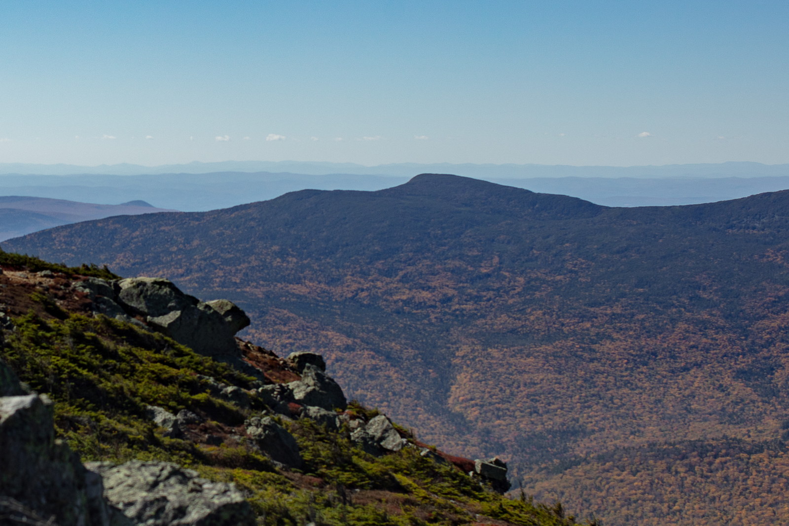 South Kinsman Mountain South Kinsman peak with fall foliage and rocky ridge under clear blue sky