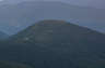 Forested mountain ridge and summit of Galehead Mountain in the White Mountain National Forest under a partly cloudy sky.