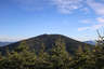 Forested mountain ridge and summit of Mount Field in the White Mountain National Forest under a partly cloudy sky.