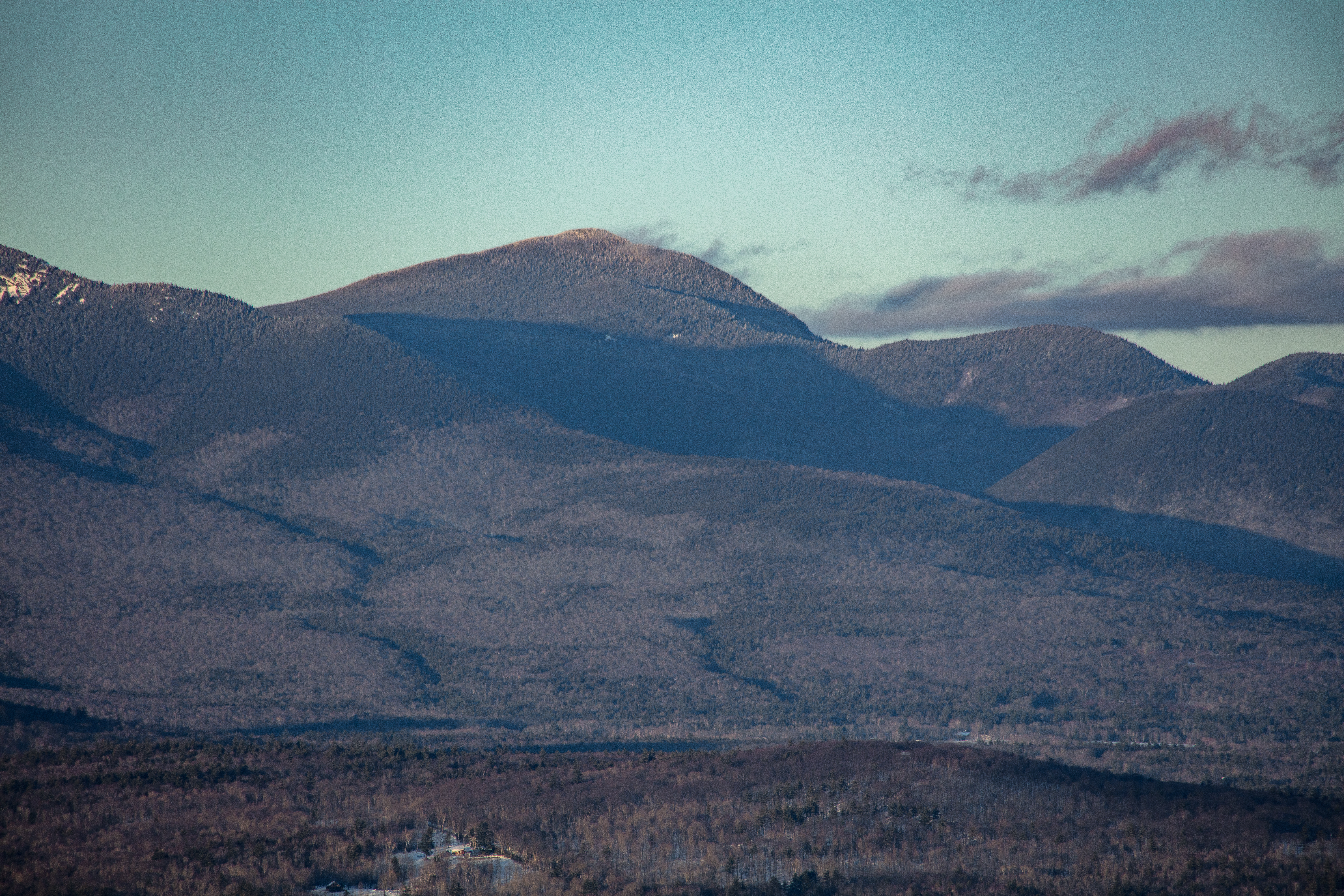 Mount Passaconaway in winter with soft afternoon light and long shadows