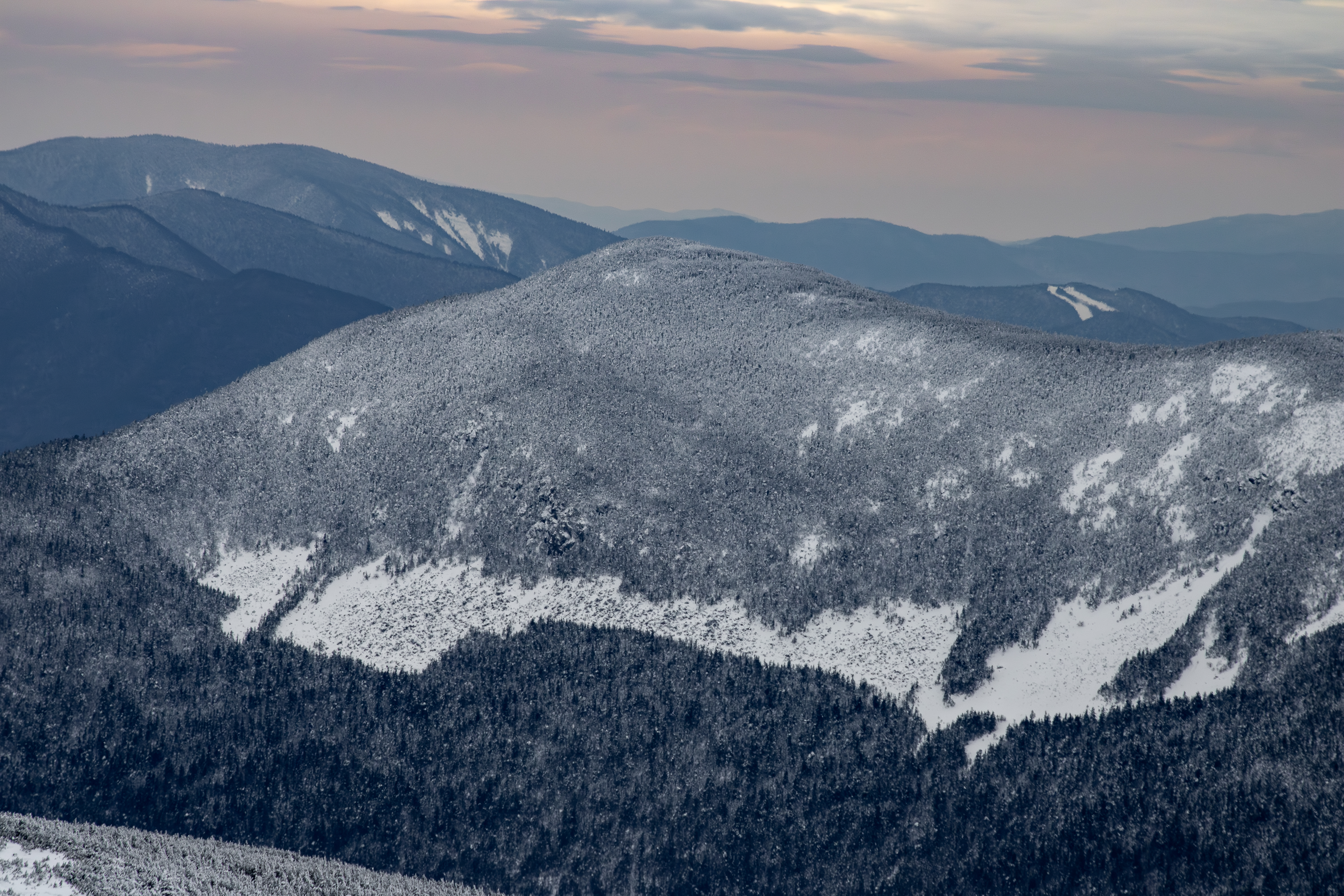 Snow-covered Mount Willey in White Mountains under cloudy winter sky